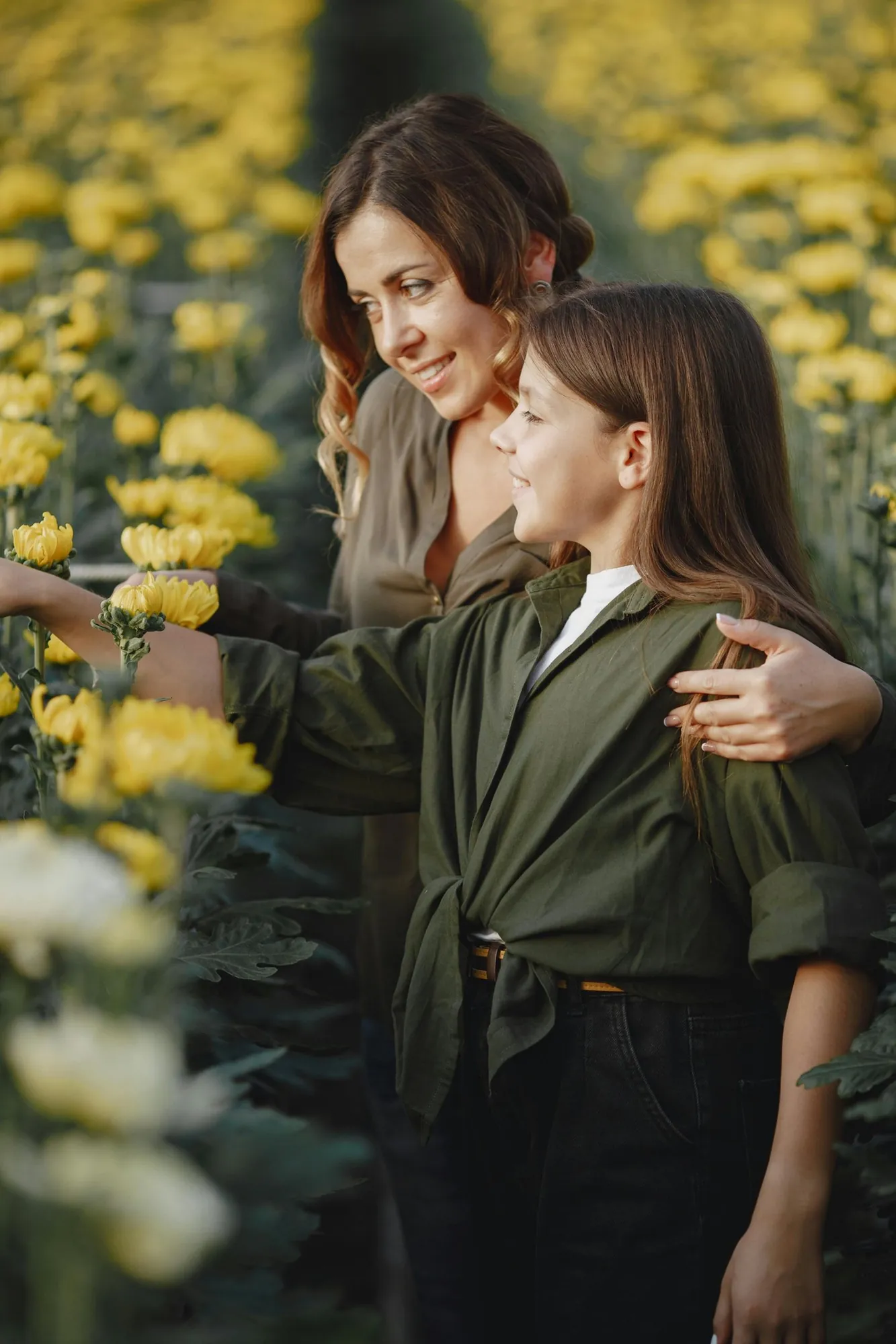 A mother and her daughter close together, foreheads almost touching.
